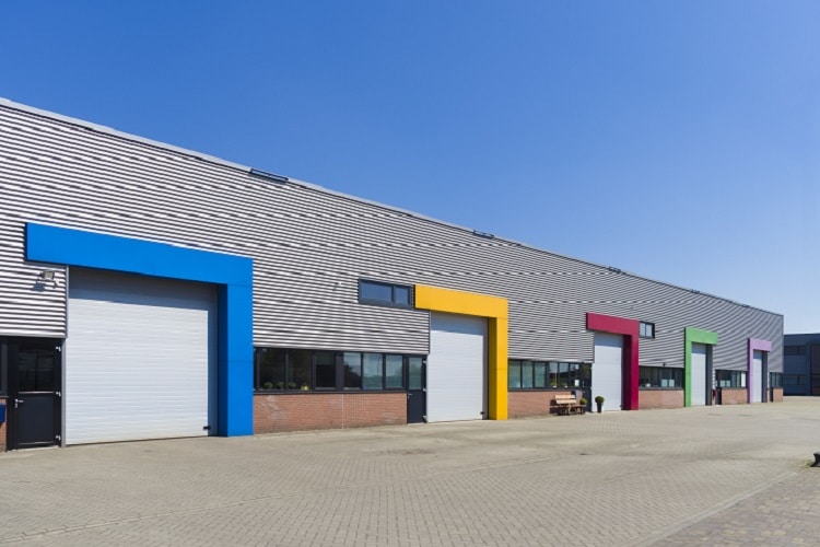 A warehouse building with multiple entrances, to indicate commercial property legal services.