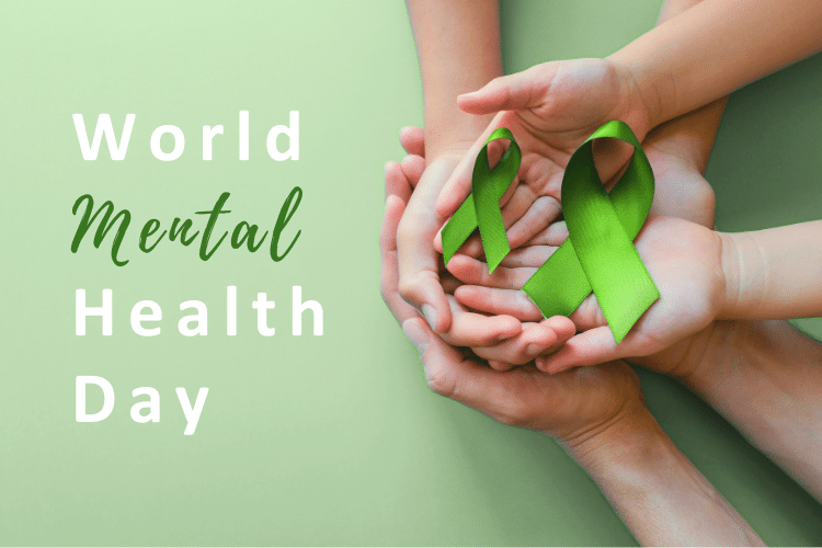two pairs of hands holding two green ribbons to show support of world mental health day.